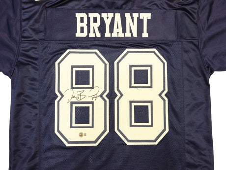 The Sports Integrity Dez Bryant Dallas Signed Navy Blue Football Jersey features BRYANT and number 88 in white, with the 88 autographed in black marker.
