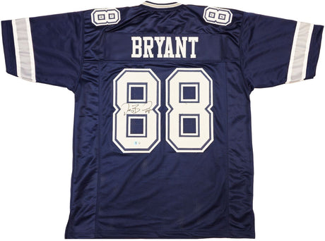 The Sports Integrity Dez Bryant Dallas Signed Navy Blue Football Jersey BAS ITP features white sleeve stripes, "BRYANT" and number 88 on the back, plus Dez Bryant's signature beside the number.