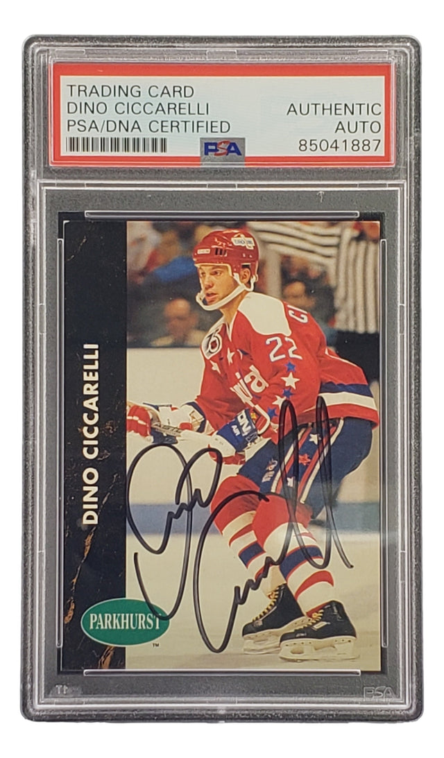 The Sports Integrity Dino Ciccarelli Signed 1991 Pro Set #193 Capitals Hockey Card is PSA/DNA certified, featuring Ciccarelli in a red Capitals uniform with #22 and holding a stick on the ice.