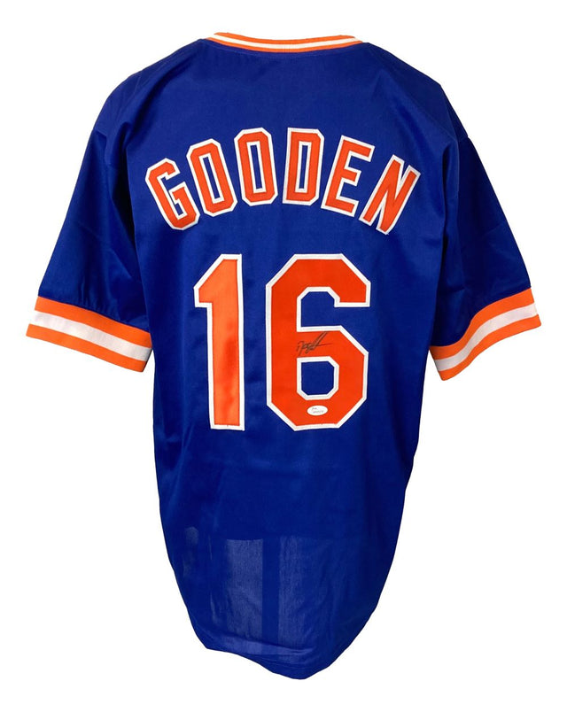 The Sports Integrity Dwight Doc Gooden New York Signed Blue Baseball Jersey JSA features "GOODEN" and number 16 on the back, with a signature on the number 6. The jersey is blue with orange and white trim.