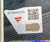 A close-up of a security sticker on the Sports Integrity The Dudley Boyz Signed Framed 16x20 WWE Photo Fanatics, showing the code KF50462220, QR code, red logo, and an 'R' hologram against a patterned background.