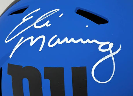 Close-up of a Sports Integrity Eli Manning Signed New York Giants FS Rave Speed Replica Helmet, featuring his white signature above “ny” on the blue helmet.