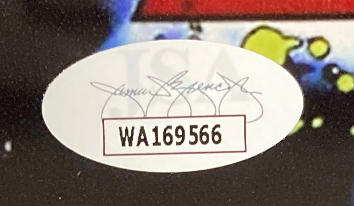 Sports Integrity Joe Elliott Phil Collen Signed Framed 12x12 Def Leppard Photo features a black background with colorful abstract shapes, a serial number WA169566 on an oval sticker, and a faint signature above. Authenticated by JSA ITP.