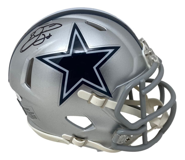 The Sports Integrity Emmitt Smith Signed Dallas Cowboys Mini Speed Replica Helmet features a silver finish, navy blue star with white outline, gray facemask, and Emmitt Smith’s black signature above the logo. JSA certified.