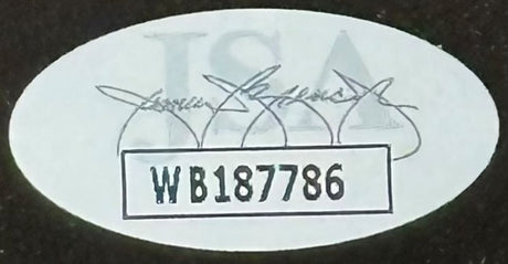 Oval sticker with faded text and signatures, showcasing "WB187786" in a bold, bordered rectangle; from Sports Integrity’s Entourage Cast Signed Framed 16x20 Photo (Grenier & others, JSA ITP).
