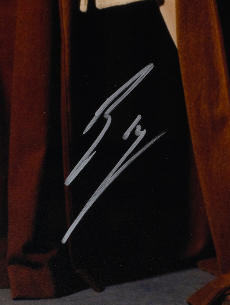 A close-up of Ewan McGregor’s white, stylized signature on a dark brown background appears on the Sports Integrity framed 16x20 Star Wars Obi-Wan Kenobi pose photo, authenticated by JSA.