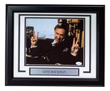 A framed 8x10 photo of Gene Hackman from Sports Integrity, featuring him smiling with a peace sign. Includes a plaque reading GENE HACKMAN and comes signed with JSA authentication.