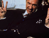 A man in a suit reclines, grinning with a cigar and flashing peace signs in the Gene Hackman Signed Framed 8x10 No Way Out Photo 2 by Sports Integrity.