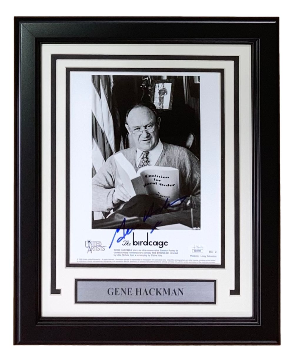 Gene Hackman Signed Framed 8x10 “The Birdcage” Photo by Sports Integrity, authenticated by JSA, featuring a black-and-white image of Hackman reading, with name plaque and "The Birdcage" (1996) label.