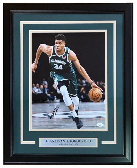 Sports Integrity Giannis Antetokounmpo Signed Framed 11x14 Milwaukee Bucks Photo with JSA Hologram features the star dribbling on court in a green uniform, autograph and nameplate included.