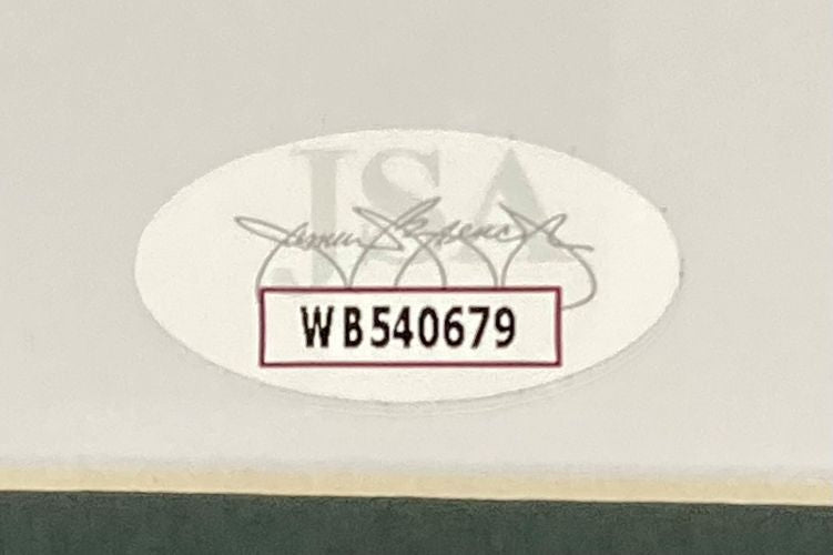 A close-up of the oval WB540679 sticker, featuring bold black text over a faint JSA logo and signature, authenticates the Sports Integrity Brandon Graham Signed Framed 16x20 Super Bowl 59 Eagles Smoke Photo.
