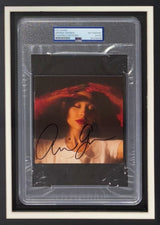 The Sports Integrity Ariana Grande Signed Framed Eternal Sunshine CD Insert with 11x14 Photo 2 (PSA) features her autograph in black ink on a striking image, authenticated and beautifully displayed for fans.