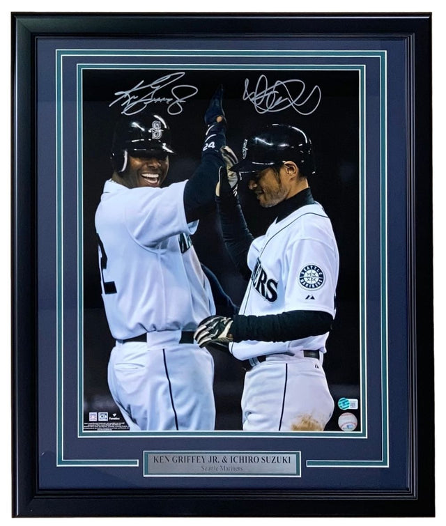 Sports Integrity Ken Griffey Jr & Ichiro Suzuki Signed Framed 16x20 Seattle Mariners Photo BAS shows both players in uniform high-fiving, with their autographs above and a plaque below featuring their names.