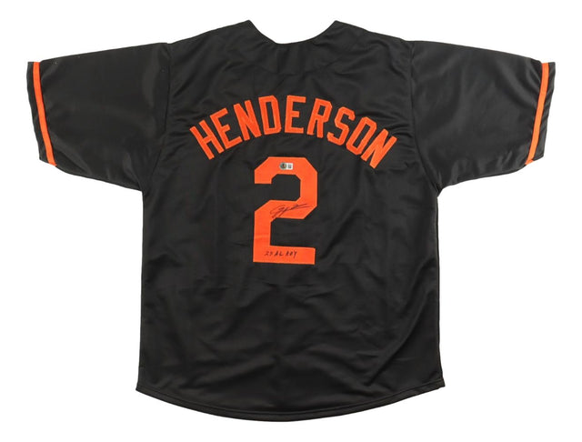 A black Gunnar Henderson Baltimore baseball jersey by Sports Integrity, featuring orange accents, his name and number 2 on the back signed and dated "23.2.14. HOF," commemorating his AL ROY award with BAS authentication.