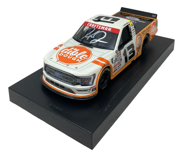 The Sports Integrity Hailie Deegan Signed 1:24 NASCAR Dible Dough Die-Cast Truck features the number 13, a “Dible Dough” logo on the hood, a white windshield signature, and is displayed on a black platform.