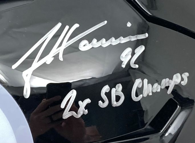 A close-up of the James Harrison Signed Steelers FS Authentic SpeedFlex Helmet by Sports Integrity shows his silver autograph, "92," and "2x SB Champs" with a phone reflection visible on the helmet’s surface.