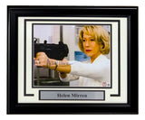 Sports Integrity Helen Mirren Signed Framed 8x10 Red Photo BAS features a framed, autographed photo of Helen Mirren in white aiming a gun, with her name displayed on a plaque below.