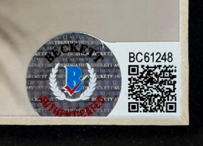 A Helen Mirren Signed Framed 8x10 Red Photo by Sports Integrity features a Beckett Authentication Services sticker with a QR code and serial number BC61248 on a beige background.