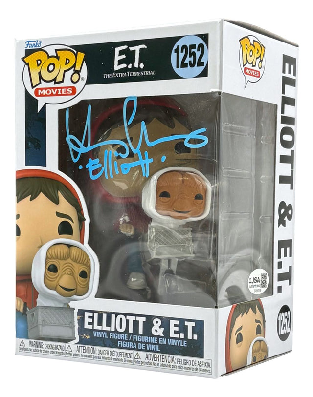 The Sports Integrity Henry Thomas Signed ET Funko Pop #1252 (JSA) features both vinyl figures in-box, with the packaging signed in blue marker.