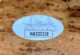 A Hideki Matsui Signed 16x20 Yankees 2009 World Series Photo by Sports Integrity features an oval sticker with a signature, faint JSA letters, and the code WA333218 printed in black on a tan textured background.