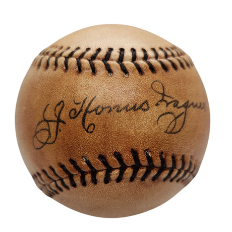 A detailed view of the Sports Integrity Honus Wagner Pirates Replica Baseball, showcasing dark stitching and a circa 1910s facsimile autograph elegantly printed on the leather surface.