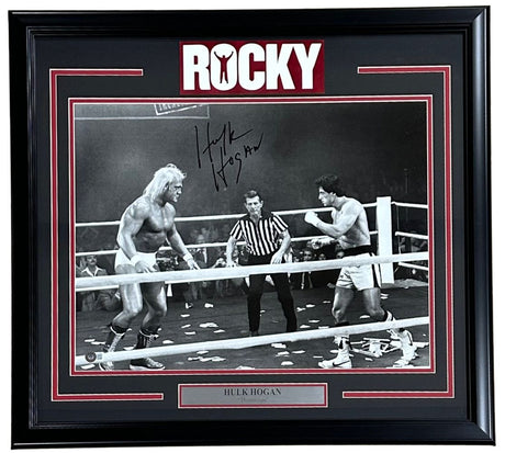 The Sports Integrity Hulk Hogan Signed Framed 16x20 Rocky vs Thunderlips Photo features a black-and-white boxing scene from Rocky, with Hulk Hogan as Thunderlips and Rocky Balboa in the ring. Signed photo with ROCKY at the top.