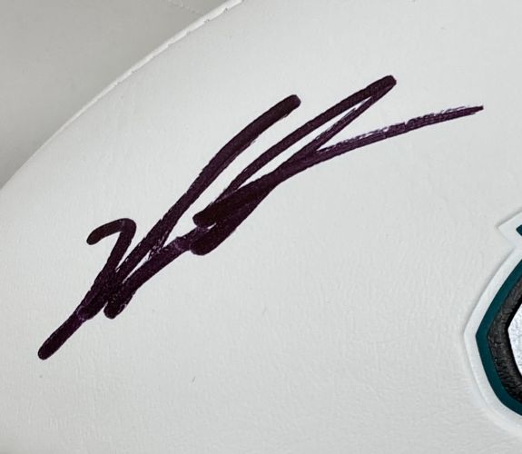 A Jalen Carter autographed Philadelphia Eagles logo football by Sports Integrity, with a black marker signature on white and part of the teal and black team logo visible. Includes BAS authentication and Super Bowl 59 (LIX) display case.