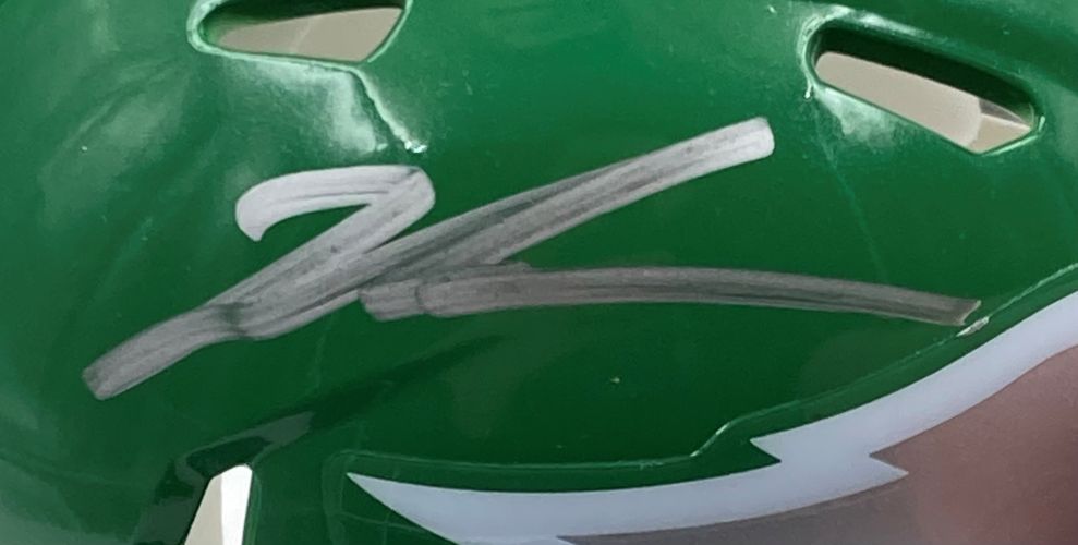 The Sports Integrity Jalen Carter Signed Eagles Kelly Green Mini Helmet features a bold silver autograph and comes with a Super Bowl 59 LIX case, plus white detailing near the lower edge.