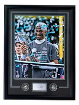 The Sports Integrity Jalen Hurts Framed 16x20 Eagles Super Bowl 59 Trophy Photo features Hurts holding the trophy, blue confetti, two commemorative coins, and a laser signature below the image.