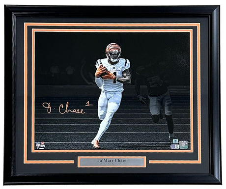 Sports Integrity Ja'Marr Chase Signed Framed 16x20 Cincinnati Bengals Spotlight Photo BAS, featuring Chase in uniform running with the ball, dark background, and a nameplate below the photo.