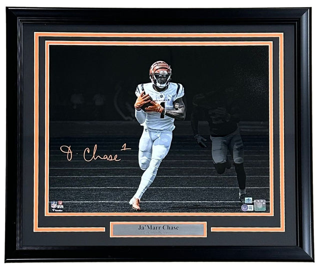 Sports Integrity Ja'Marr Chase Signed Framed 16x20 Cincinnati Bengals Spotlight Photo BAS, featuring Chase in uniform running with the ball, dark background, and a nameplate below the photo.