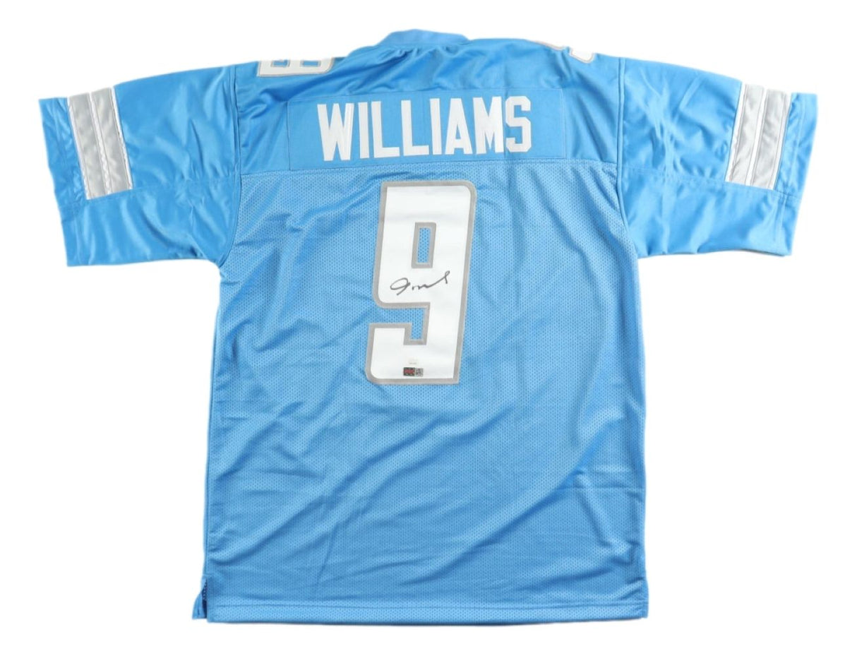 The Jameson Williams Detroit Signed Light Blue Football Jersey by Sports Integrity features silver and white sleeve stripes, WILLIAMS and number 9 on the back, plus a JSA hologram for authenticity.