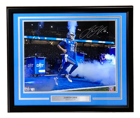 Sports Integrity Jared Goff Signed Framed 16x20 Detroit Lions Photo by Fanatics, featuring the quarterback (#16) running onto the field through smoke, with a blue border and nameplate.