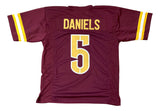 The Sports Integrity Jayden Daniels Washington Burgundy Football Jersey features yellow and white sleeve stripes, with "DANIELS" and the number 5 in bold yellow on the back.