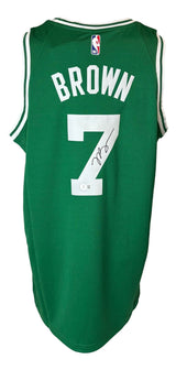 A green Boston Celtics Nike Swingman jersey by Sports Integrity, featuring BROWN and number 7 on the back, an NBA logo, and Jaylen Brown’s autograph authenticated by BAS.