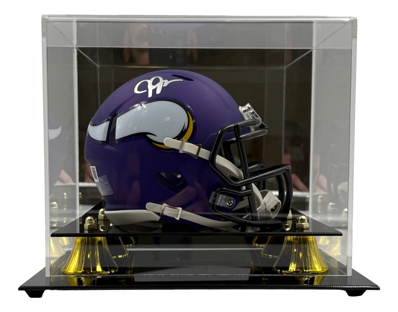 The Sports Integrity Justin Jefferson Signed Minnesota Vikings Mini Speed Helmet is displayed in a clear acrylic case with a black and gold base.