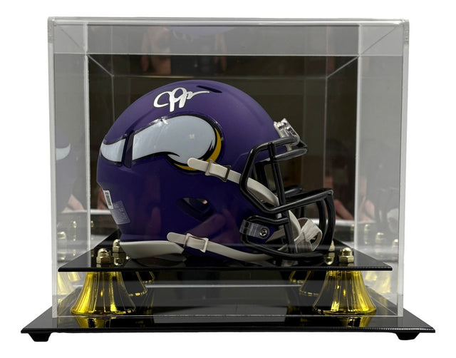 The Sports Integrity Justin Jefferson Signed Minnesota Vikings Mini Speed Helmet is displayed in a clear acrylic case with a black and gold base.
