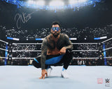 The Sports Integrity Jey Uso Signed 16x20 WWE Kneeling Photo shows Jey Uso in the ring, surrounded by cheering fans with lit phones in a bright arena—a must-have for WWE collectors.