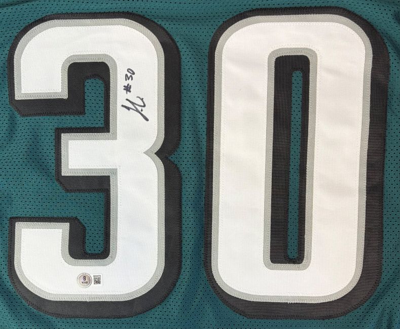 The Sports Integrity Jihaad Campbell Philadelphia Signed Green Football Jersey features a large white and black number 30, with a small autograph and "#30" in black marker on the top left of the number 3.
