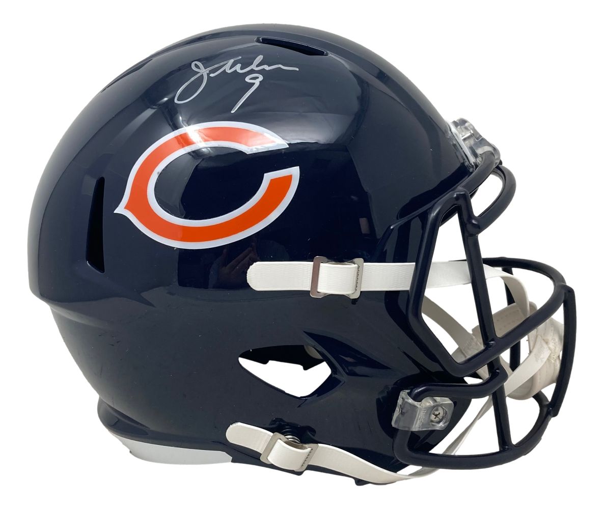 The Sports Integrity Jim McMahon Signed Chicago Bears Full Size Replica Speed Helmet BAS features a dark blue helmet with a white facemask and chin strap, adorned with the team logo and Jim McMahon's silver signature on top.