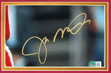 The Sports Integrity Joe Montana Signed Framed Cut Signature features his bold gold autograph on an 8x10 San Francisco 49ers photo, highlighted by a red and gold border and an authentication sticker in the bottom right corner.