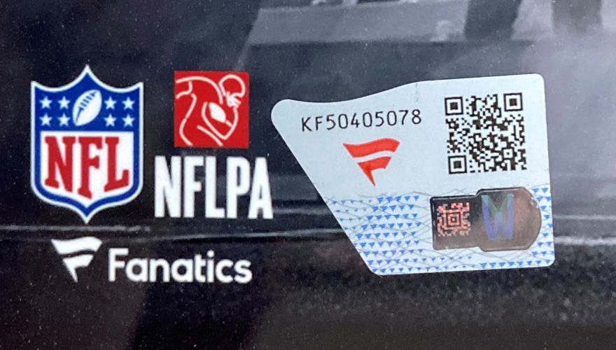 Close-up of Sports Integrity, NFL, NFLPA, and Fanatics logos by a tamper-evident sticker with QR code, serial KF50405078, and hologram on a Justin Herbert Signed Framed 11x14 Los Angeles Chargers Photo Fanatics.