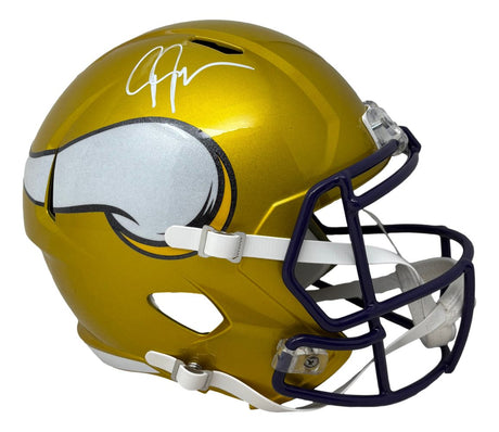 The Justin Jefferson Signed Minnesota Vikings FS Flash Replica Speed Helmet by Sports Integrity features a gold helmet with white horn logo, white facemask, and his signature in white marker on top.