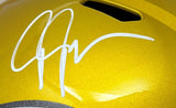 Close-up of a Justin Jefferson Signed Minnesota Vikings FS Flash Replica Speed Helmet by Sports Integrity, showcasing a bold white autograph on the shiny gold surface and a black vent near the top.