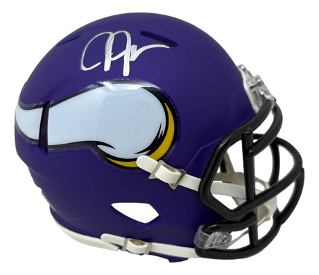 A Justin Jefferson Signed Minnesota Vikings Mini Speed Helmet by Sports Integrity, featuring a purple shell with a white horn logo and silver autograph, shown from a side angle.