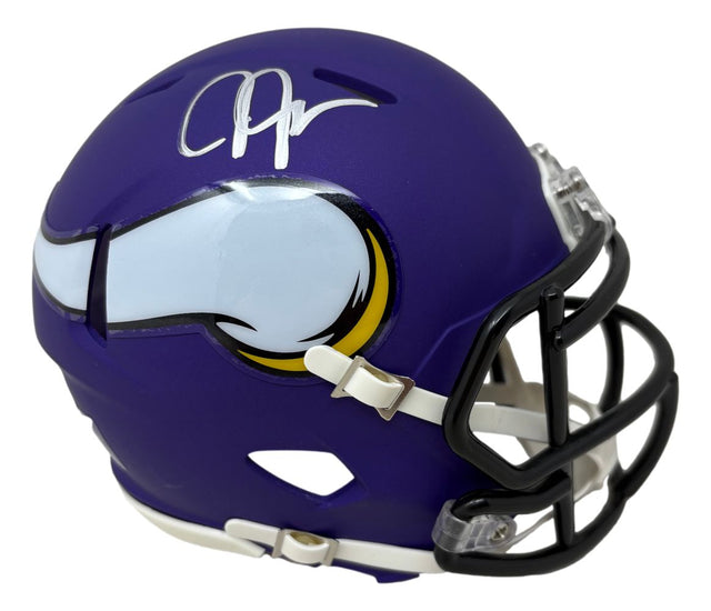 A Justin Jefferson Signed Minnesota Vikings Mini Speed Helmet by Sports Integrity, featuring a purple shell with a white horn logo and silver autograph, shown from a side angle.