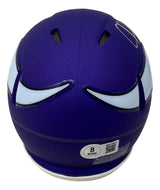The Sports Integrity Justin Jefferson Signed Minnesota Vikings Mini Speed Helmet BAS features a purple shell, white and black stylized wing decals, top ventilation slits, and a certification sticker near the bottom.