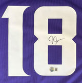 A Justin Jefferson Signed Minnesota Vikings Nike Game Jersey by Sports Integrity features a large white number 18, with the number 8 signed in black ink and an authenticity sticker at the bottom.