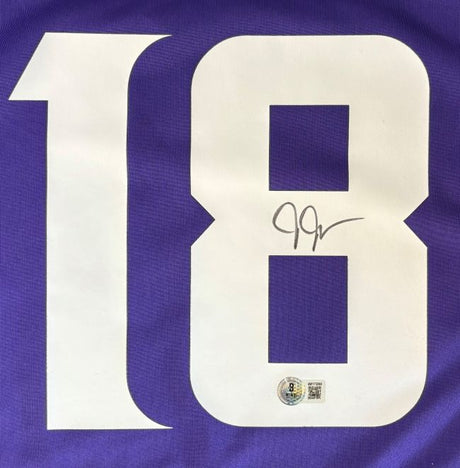 A Justin Jefferson Signed Minnesota Vikings Nike Game Jersey by Sports Integrity features a large white number 18, with the number 8 signed in black ink and an authenticity sticker at the bottom.