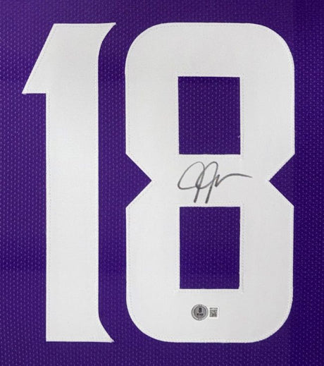 Close-up of a Justin Jefferson Minnesota Signed Framed Purple Football Jersey by Sports Integrity, featuring a large white number 18. The number 8 displays his black ink signature with an authentication sticker below it.